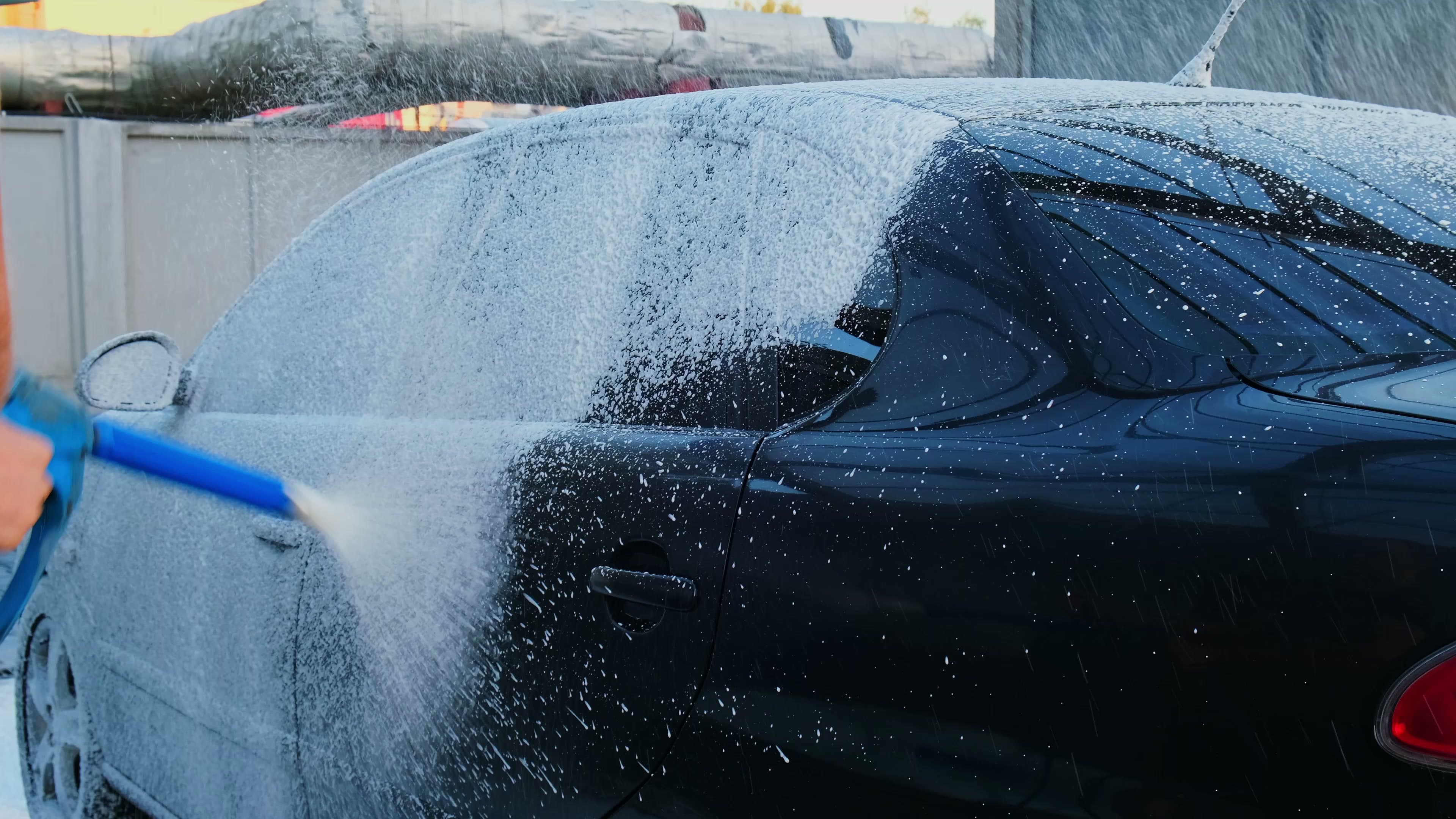 Vehicle being washed by hand with thick foam